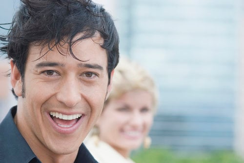 Man in focus smiling at camera