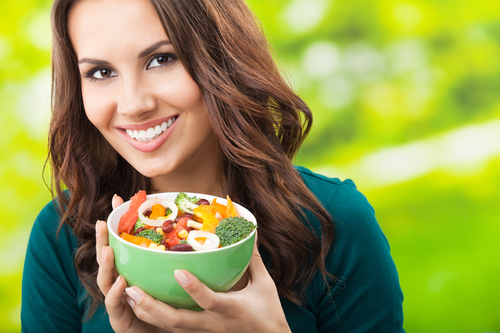 Woman holding bowl with food
